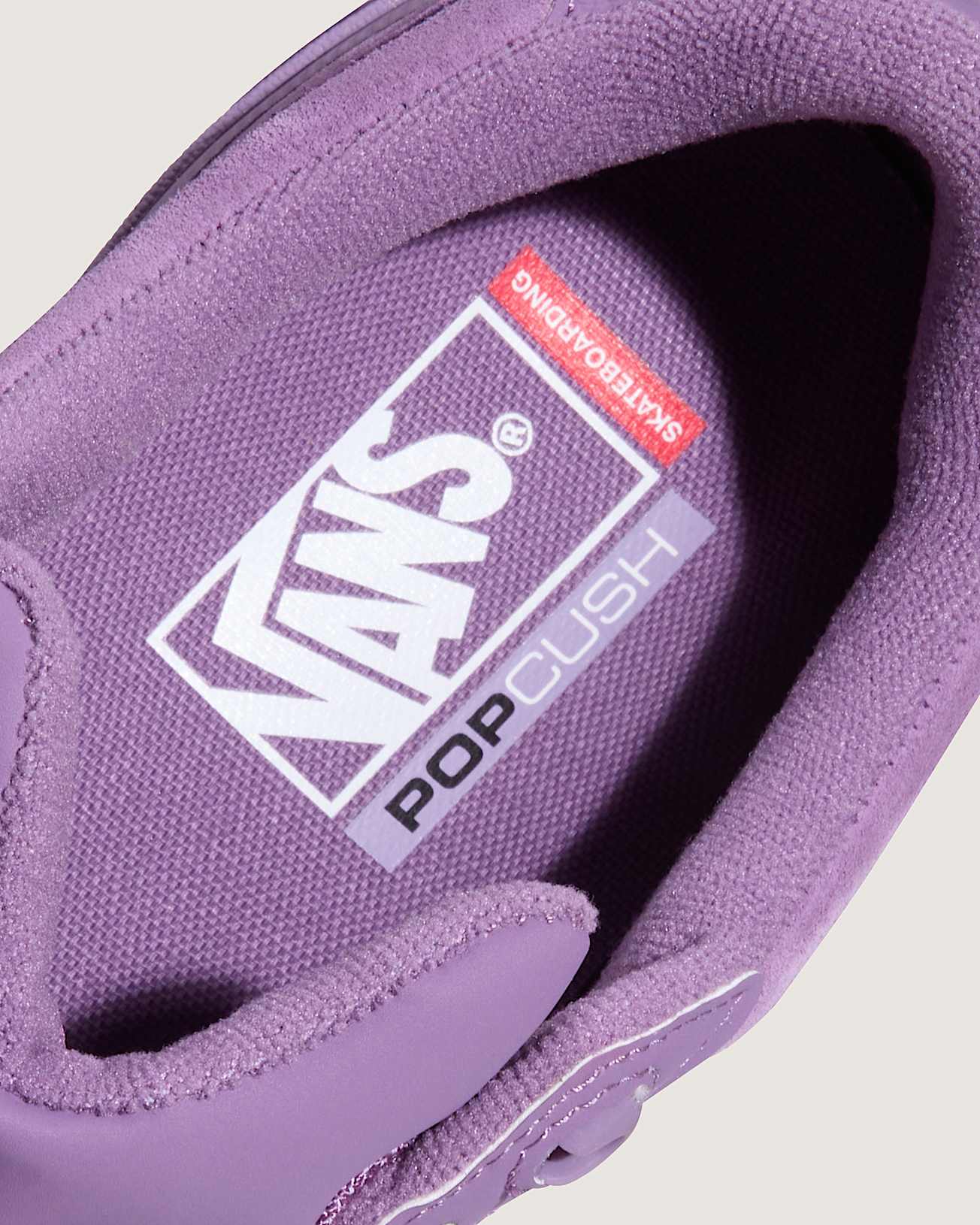 Purple Vans sneaker with 'Pop Cush' label on a light gray background