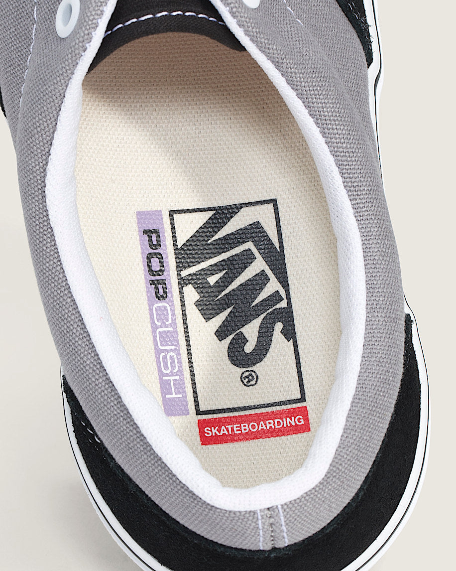 Close-up of a Vans sneaker with a focus on the brand logo and text.