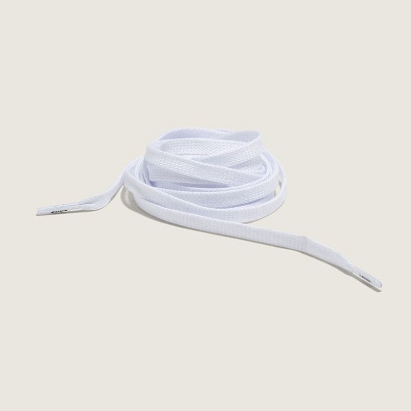 White shoelace on a light beige background