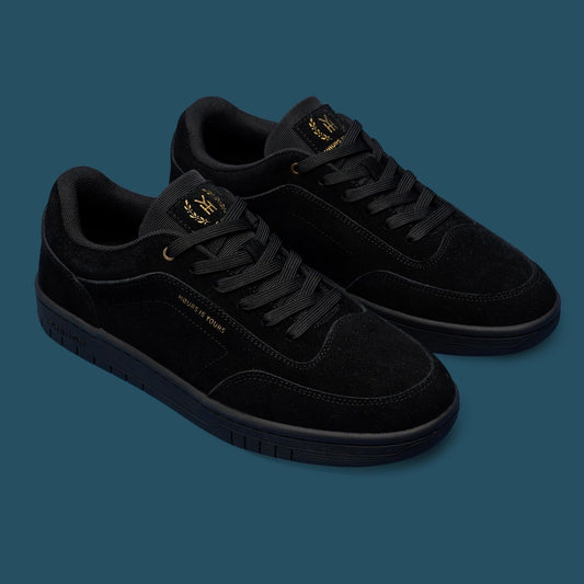 Black sneakers with gold accents on a transparent background