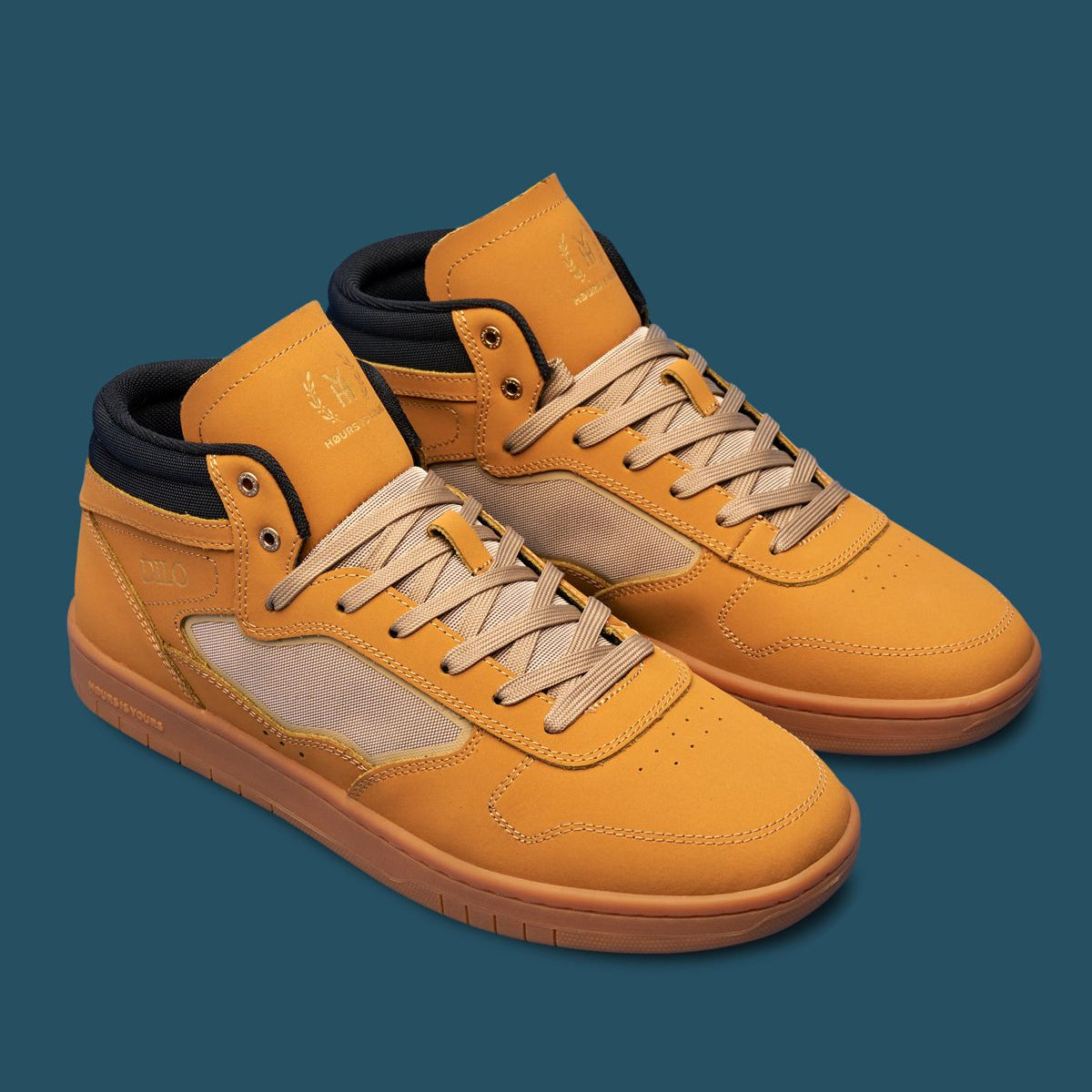 Pair of yellow high-top sneakers with black accents on a blue background