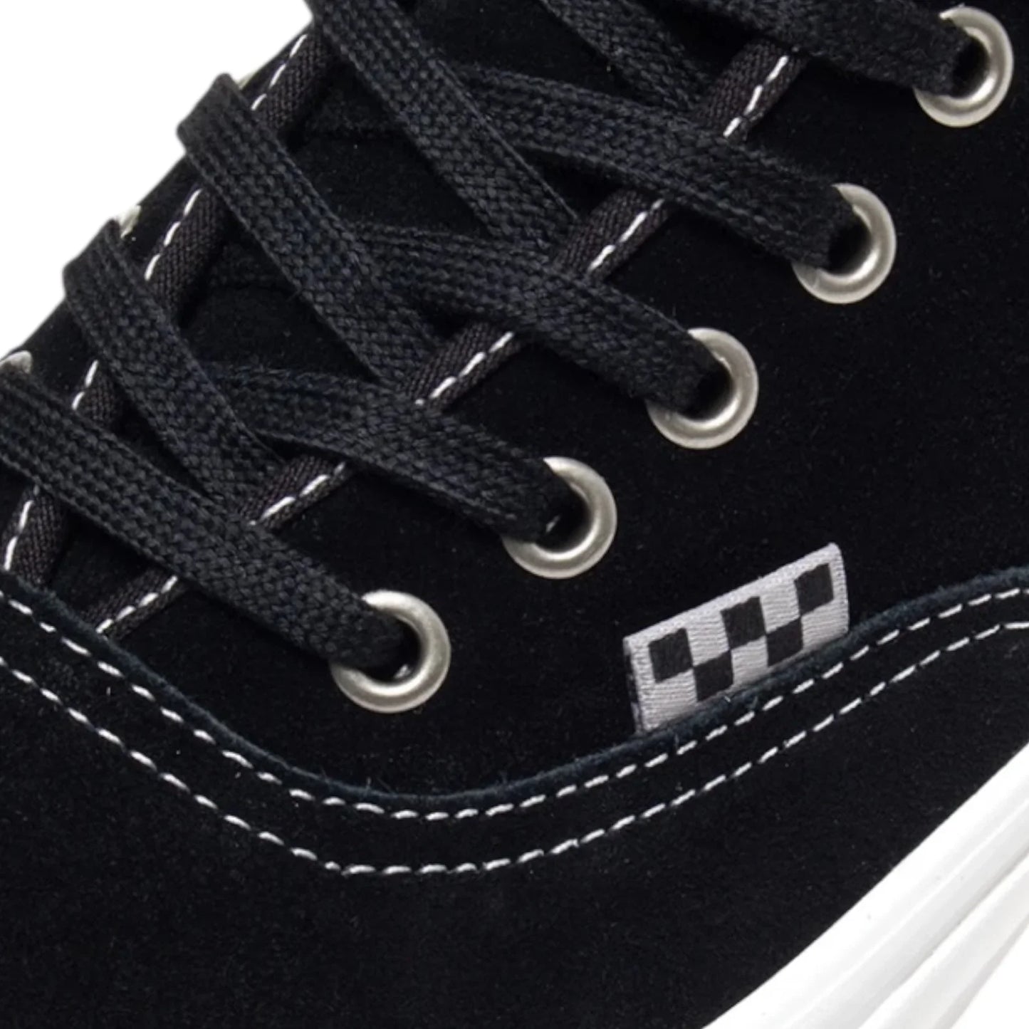 Close-up of a black sneaker with white laces and a checkered logo on a white background