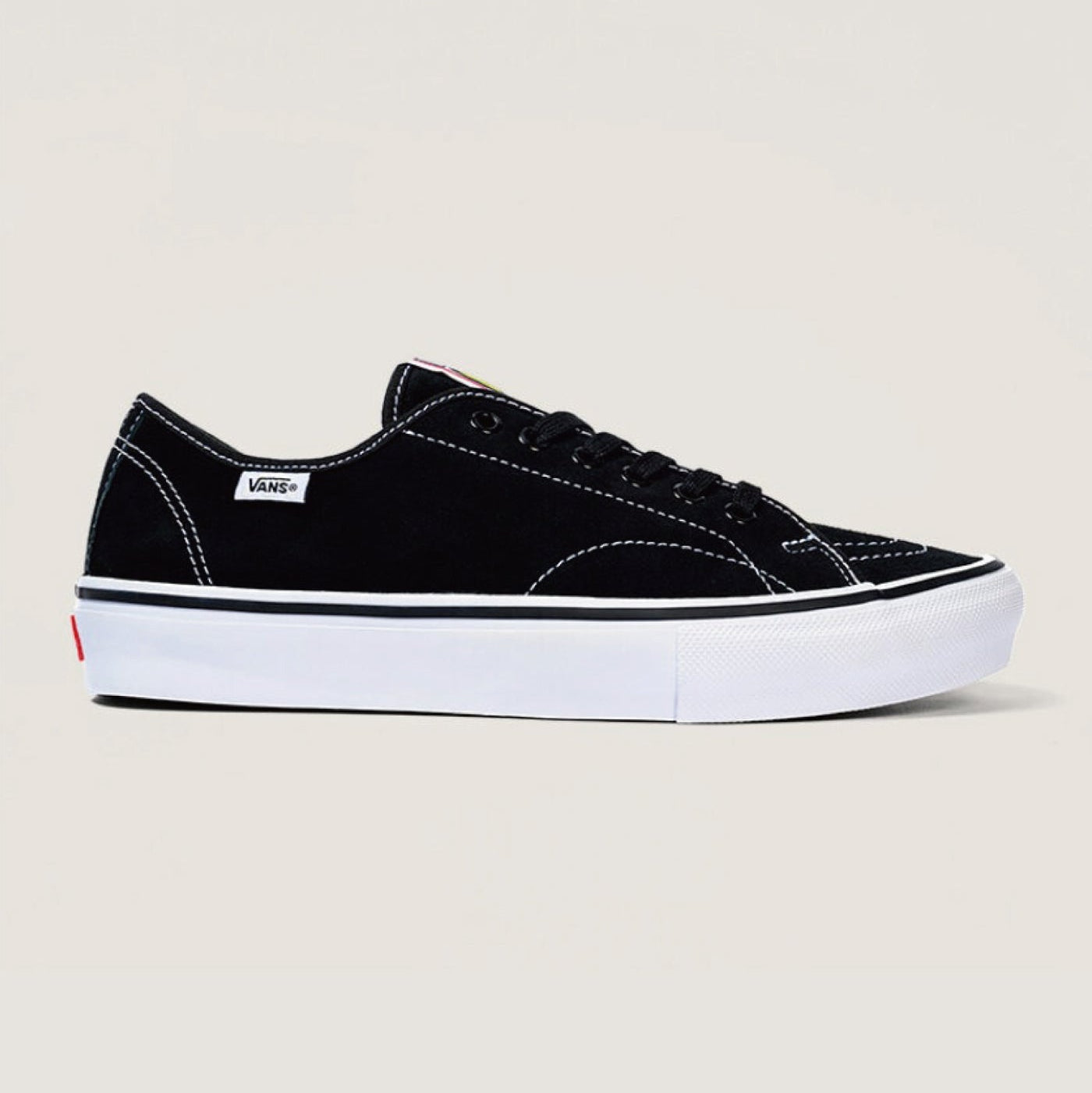 A black Vans platform sneaker with a thick white sole, white contrast stitching, and a small white Vans side tag, shown against a light beige background.