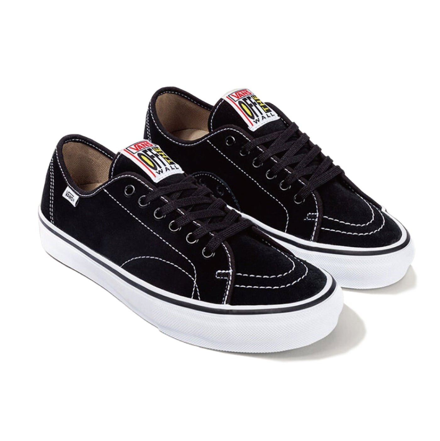 A pair of black suede low-top sneakers with white rubber soles, black laces, and a colorful Vans logo patch on the tongue, displayed on a clean white background.