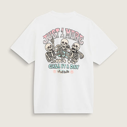 A white short-sleeve t-shirt with a colorful graphic on the back featuring three skeletons and the text 'JUST A HIDE CALL IT A DAY' and 'visits', displayed on a light beige background.