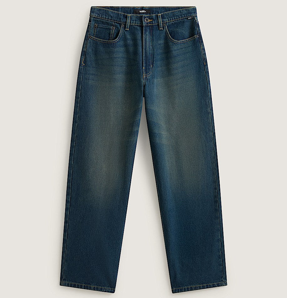 A pair of dark blue denim jeans with a subtle vertical fade wash, laid flat against a light beige background.