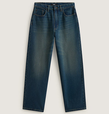 A pair of dark blue denim jeans with a subtle vertical fade wash, laid flat against a light beige background.