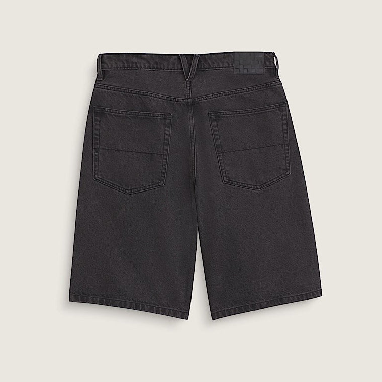 Black denim shorts on a light beige background