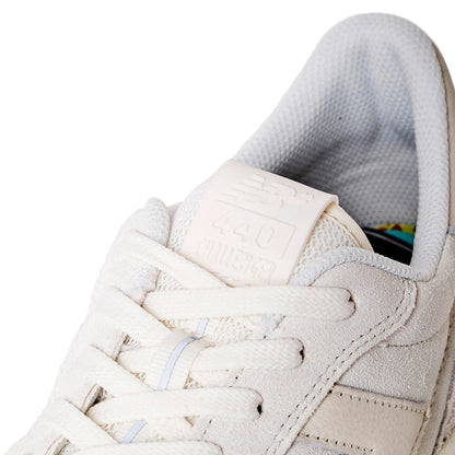 Close-up of a beige sneaker with white laces on a white background