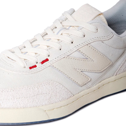 White sneaker with red accents on a white background