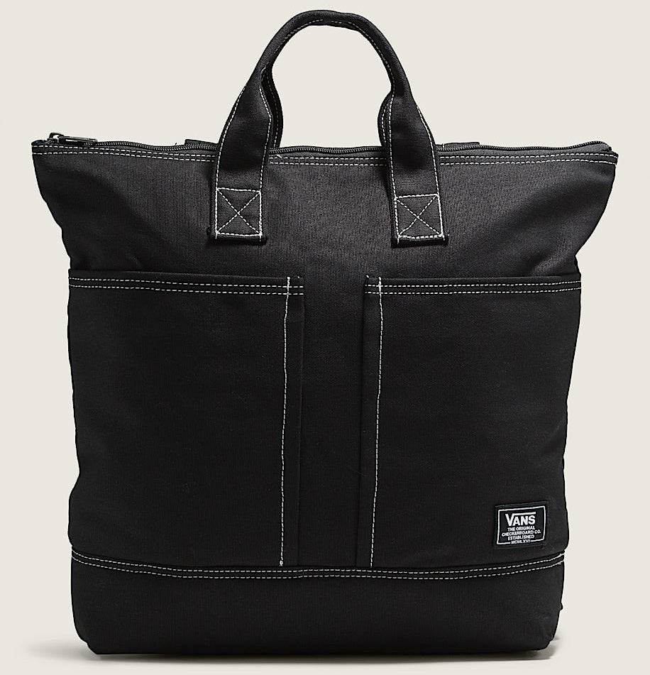 Black tote bag with a visible brand logo on a beige background