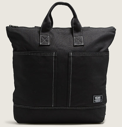 Black tote bag with a visible brand logo on a beige background