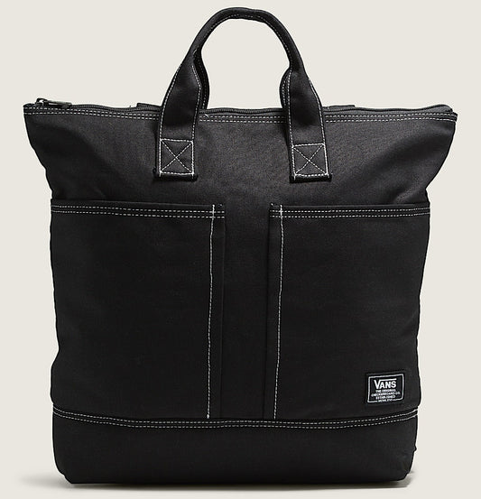 Black tote bag with a visible brand logo on a beige background