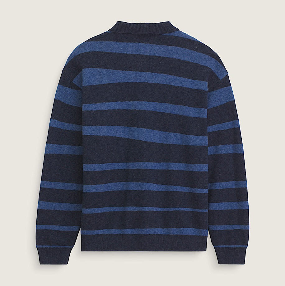 Navy and blue striped sweater on a light beige background