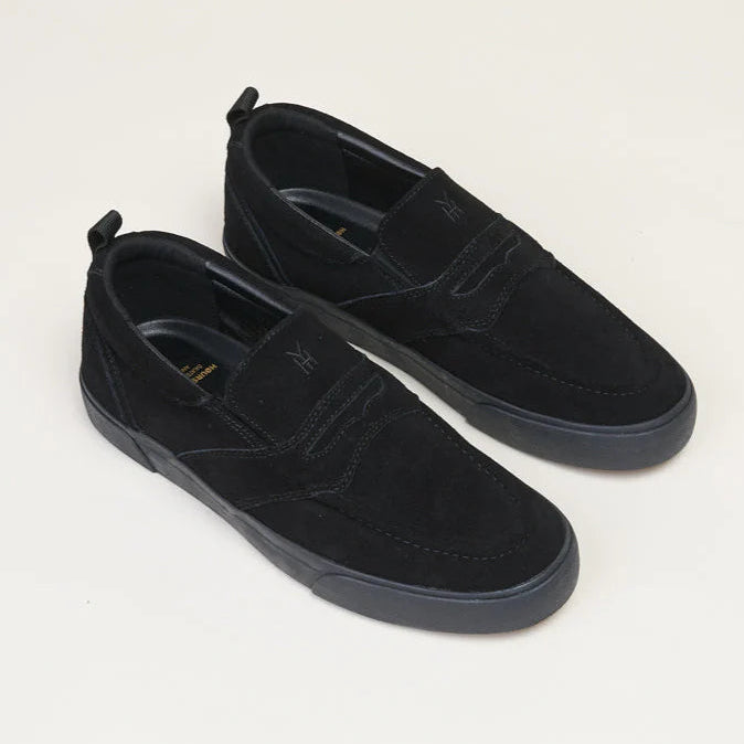 Pair of black suede shoes on a light gray background