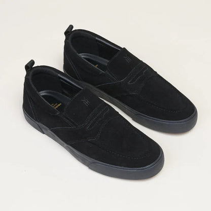 Pair of black suede shoes on a light gray background
