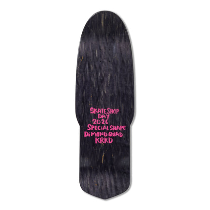 Black skateboard deck with pink text on a white background