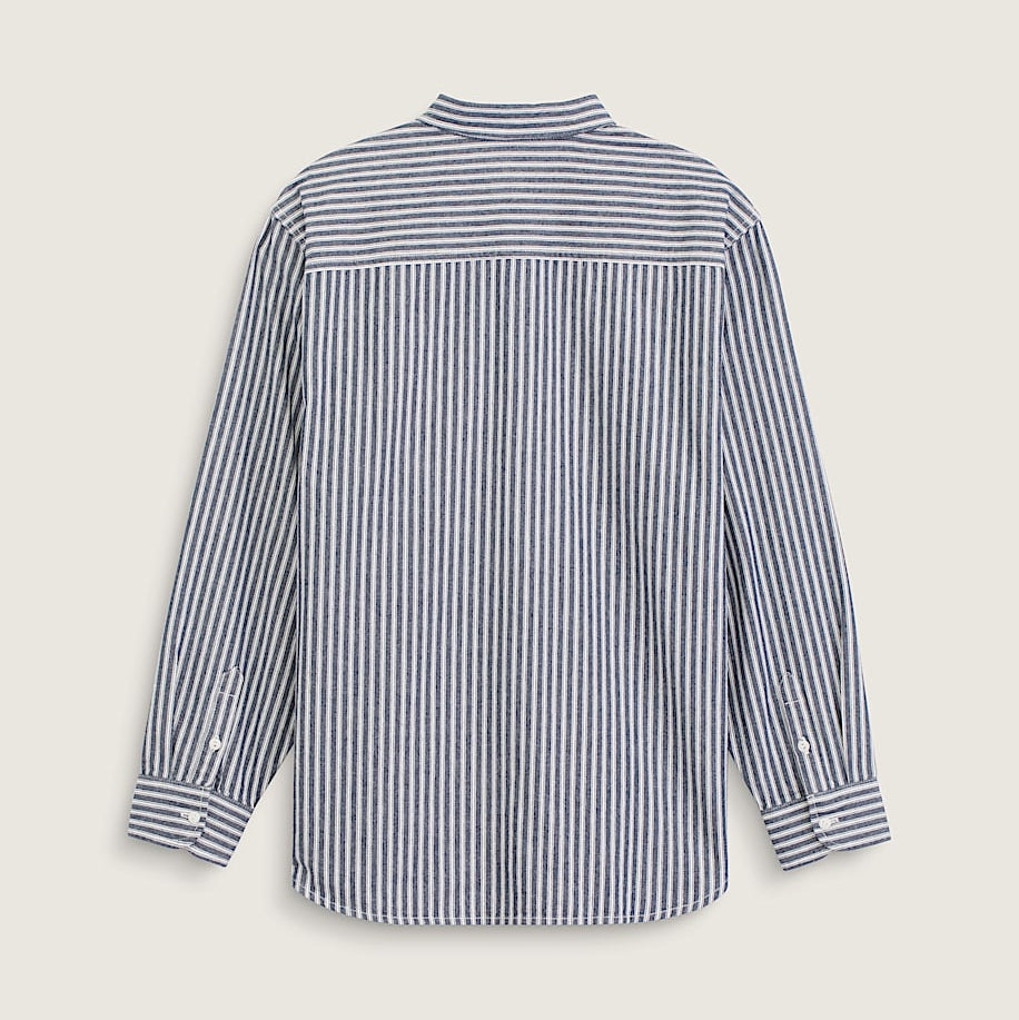 A long-sleeve button-up shirt with vertical navy and white stripes, shown from the back on a light beige background.