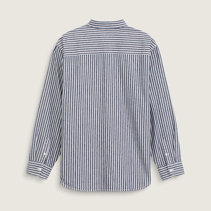 A long-sleeve button-up shirt with vertical navy and white stripes, shown from the back on a light beige background.