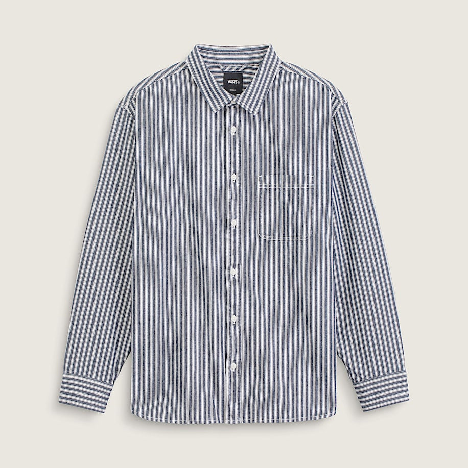 A long-sleeve button-up shirt with vertical navy and white stripes, featuring a classic collar, white buttons, and a single chest pocket, displayed against a light beige background.