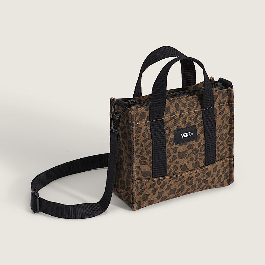 Leopard print bag with black straps on a light beige background