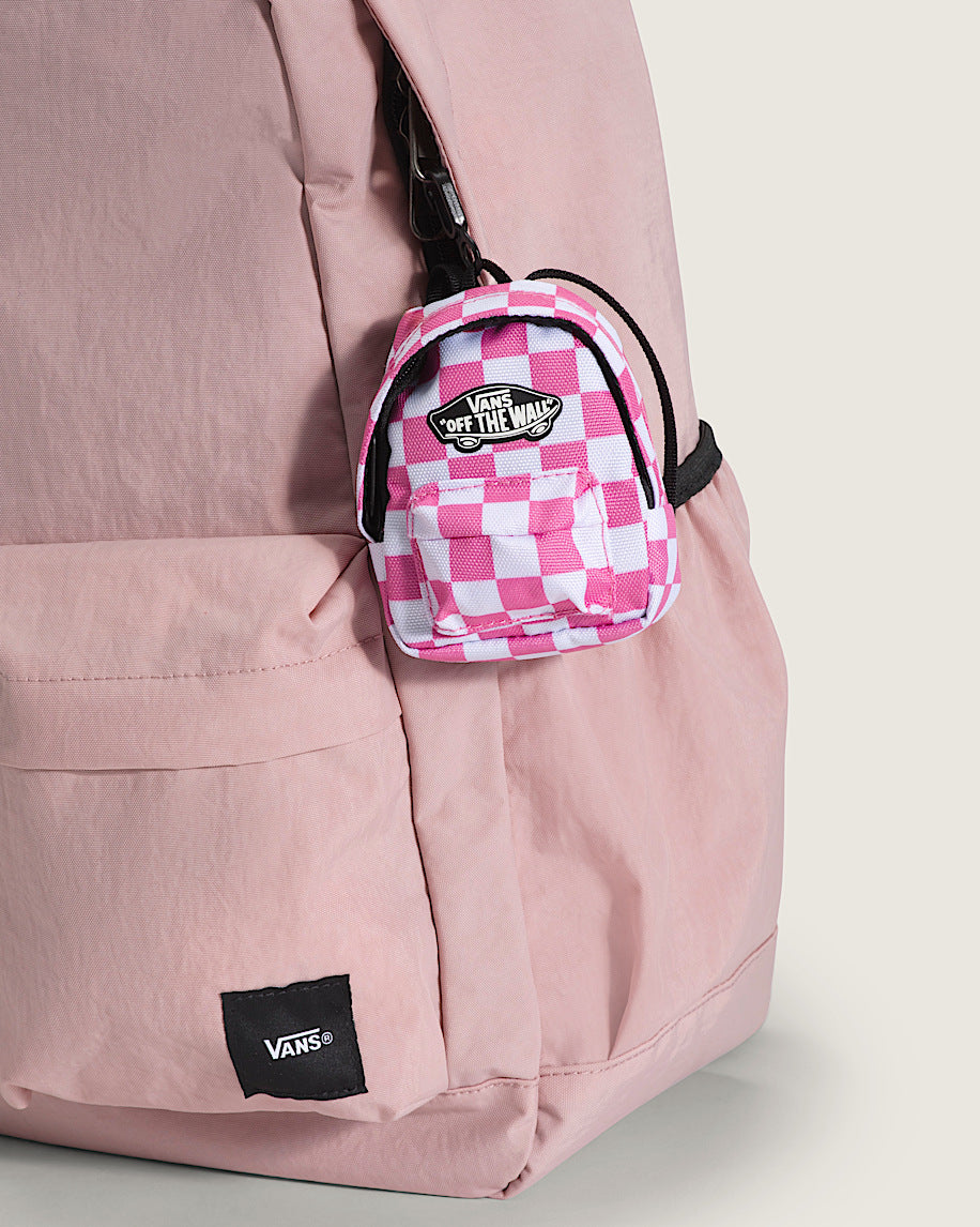 Pink checkered mini backpack with Vans logo on a pink jacket.