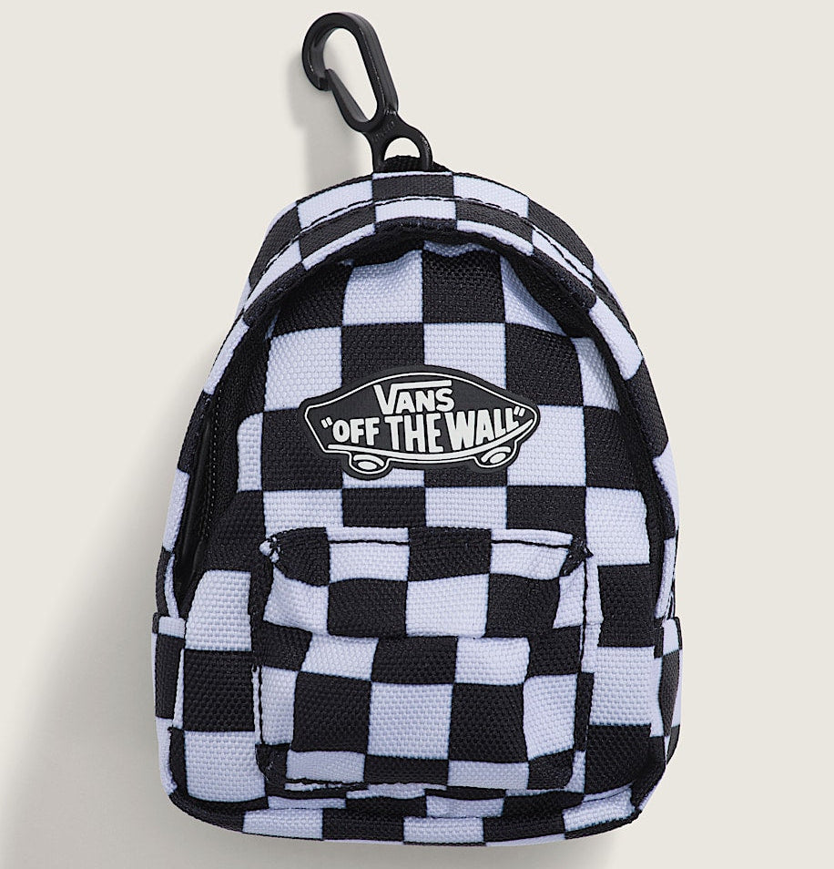 A small Vans 'Off The Wall' checkered backpack keychain or mini bag featuring a black and white checkerboard pattern, a black carabiner clip, and the brand's logo patch on the front, set against a light beige background.