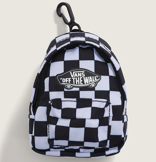 A small Vans 'Off The Wall' checkered backpack keychain or mini bag featuring a black and white checkerboard pattern, a black carabiner clip, and the brand's logo patch on the front, set against a light beige background.