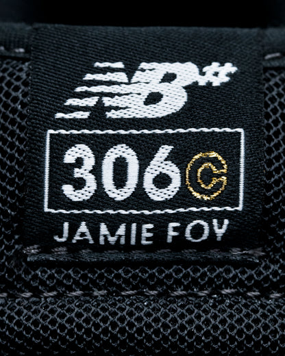 Close-up of a New Balance label with '306 C Jamie Foy' on a black background