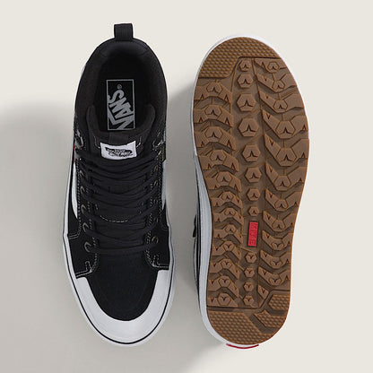 Black high-top sneaker with brown sole on a light gray background