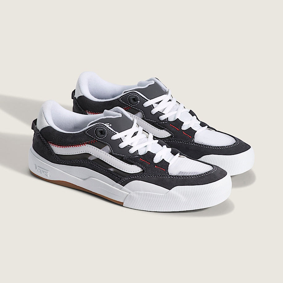 Pair of black and white sneakers on a light gray background