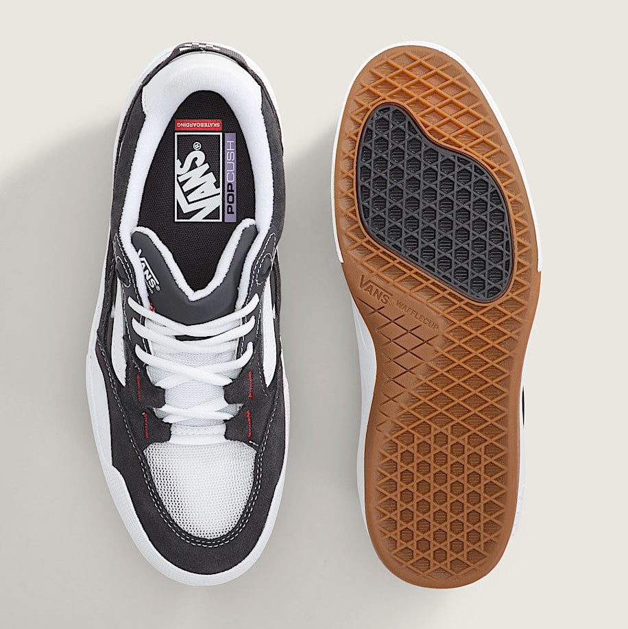 Sneaker with brown sole on a light gray background