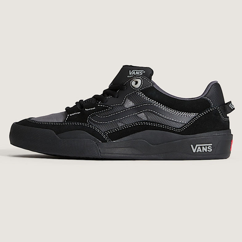 Black Vans sneaker on a light gray background b