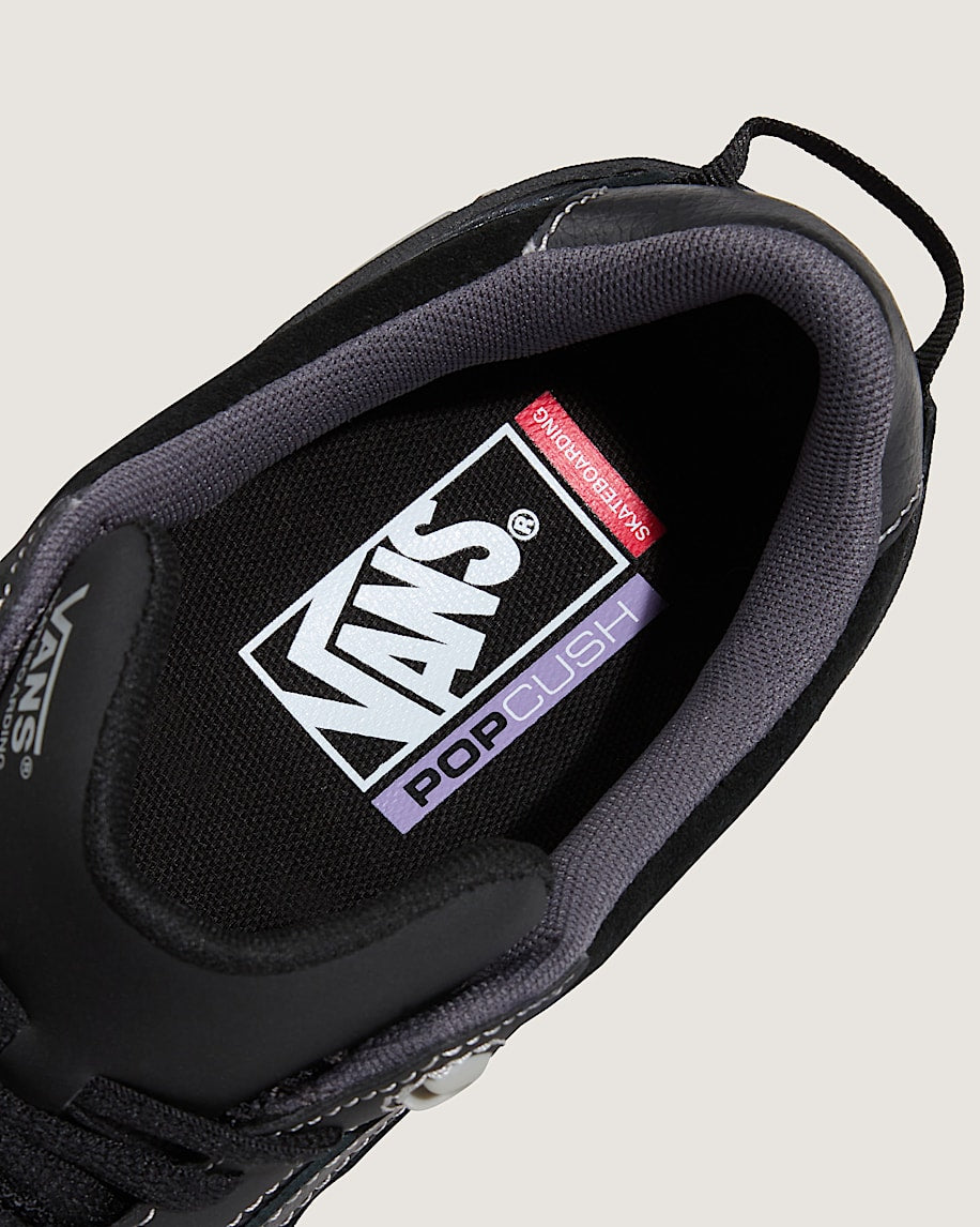 Close-up of a Vans sneaker with 'Pop Cush' label on a light gray background