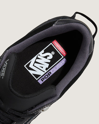 Close-up of a Vans sneaker with 'Pop Cush' label on a light gray background
