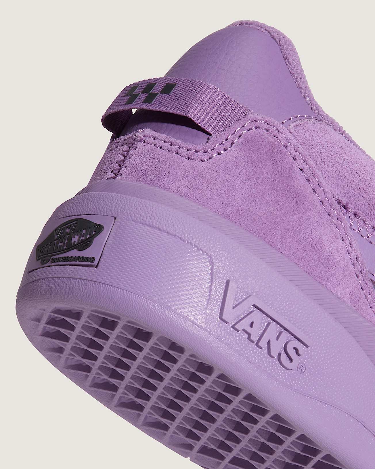 Purple Vans sneaker on a light beige background