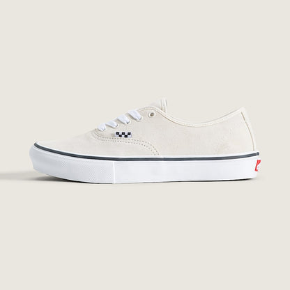 A classic low-top canvas sneaker in off-white, featuring white laces, a black and white checkered logo on the side, and a white rubber sole with a thin black stripe.