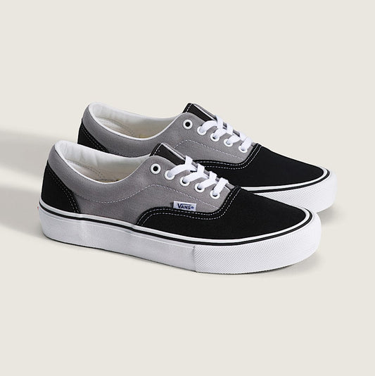 Black and gray sneakers with white soles on a light background