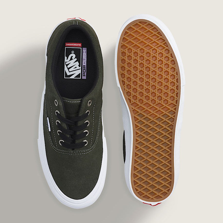 A pair of Vans platform sneakers shown from the top and bottom views. The shoe upper is olive green suede with black laces, a thick white platform sole, and a brown waffle-patterned rubber outsole.