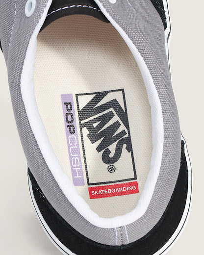 Close-up of a Vans sneaker with a focus on the brand logo and text.