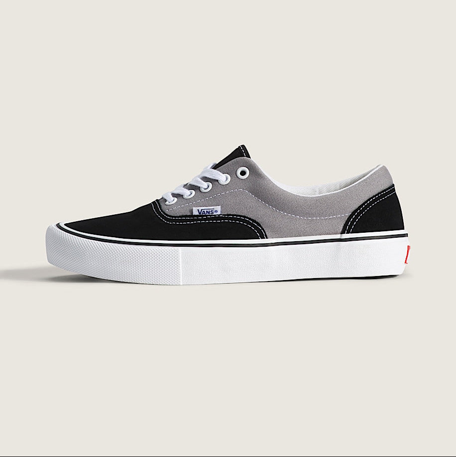Black and gray sneaker with white sole on a light gray background