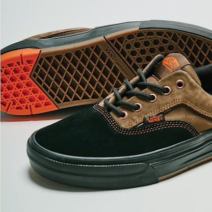 Pair of Vans shoes with a focus on the sole and side profile on a light gray background.