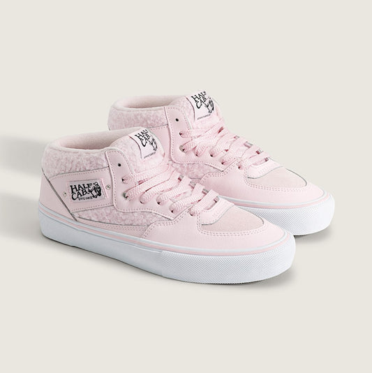 Pair of light pink high-top sneakers on a white background