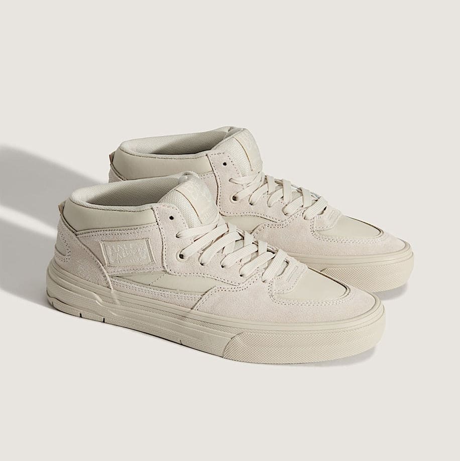 Pair of beige sneakers on a light gray background
