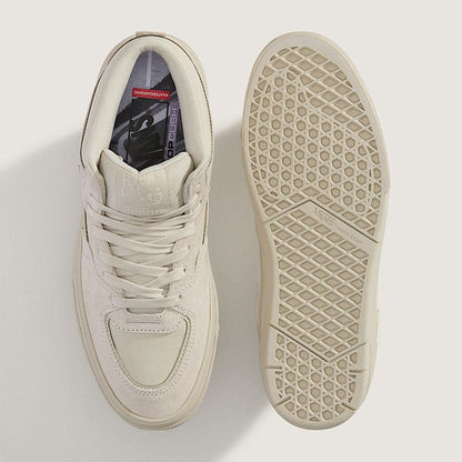 Beige sneaker with a focus on sole texture on a light gray background