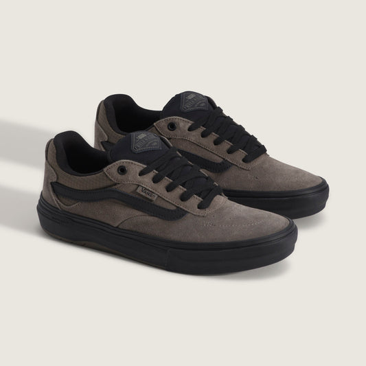 Pair of black leather shoes with a buckle on a white background