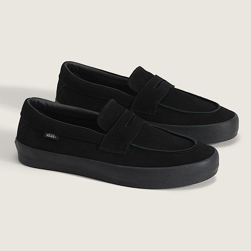 Pair of black loafers on a light gray background