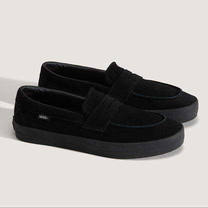Pair of black loafers on a light gray background