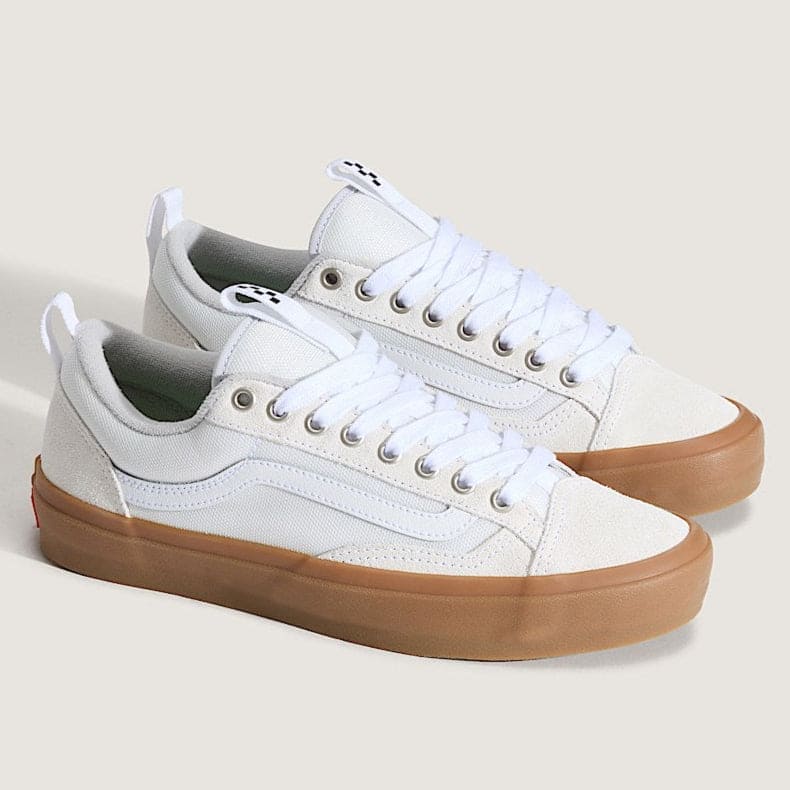 White sneakers with brown soles on a light gray background