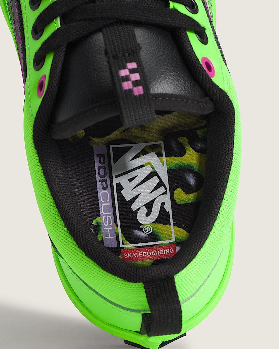 Close-up of a green and black Vans sneaker with visible branding.